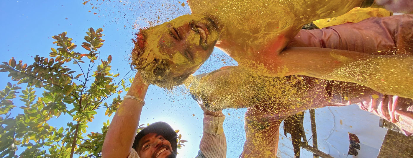 People having fun with yellow colour powder
