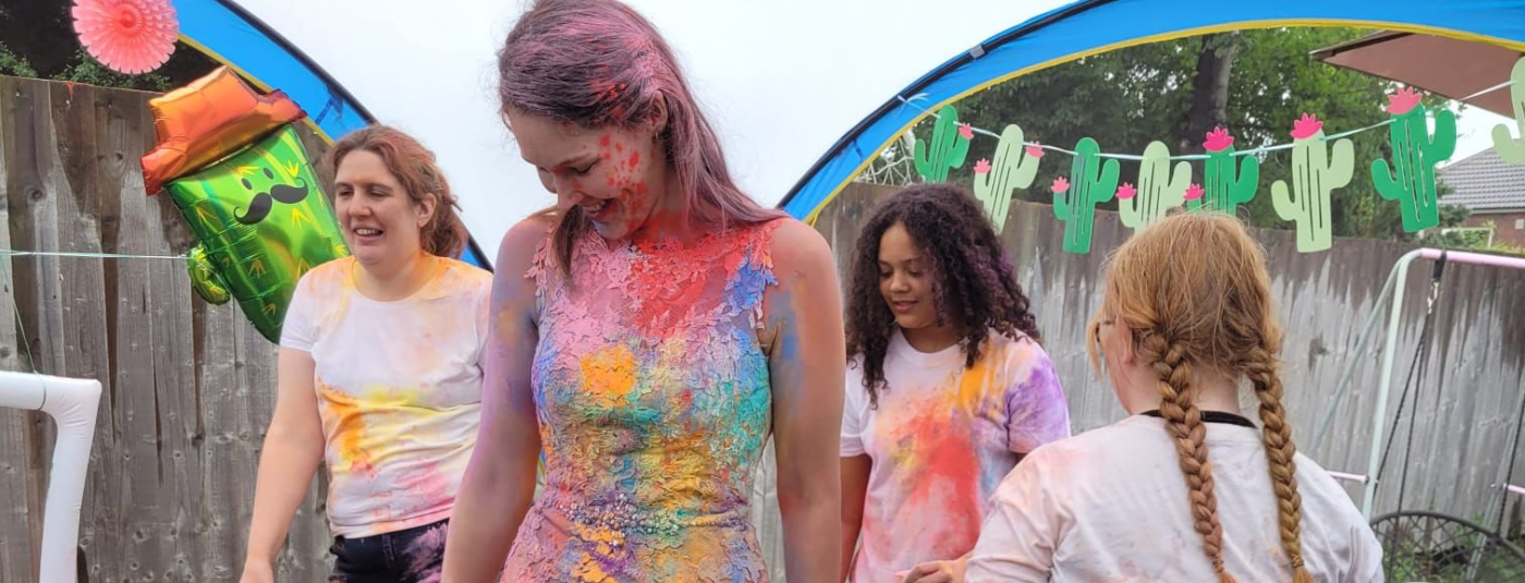 Megan in her wedding dress covered in colour powder