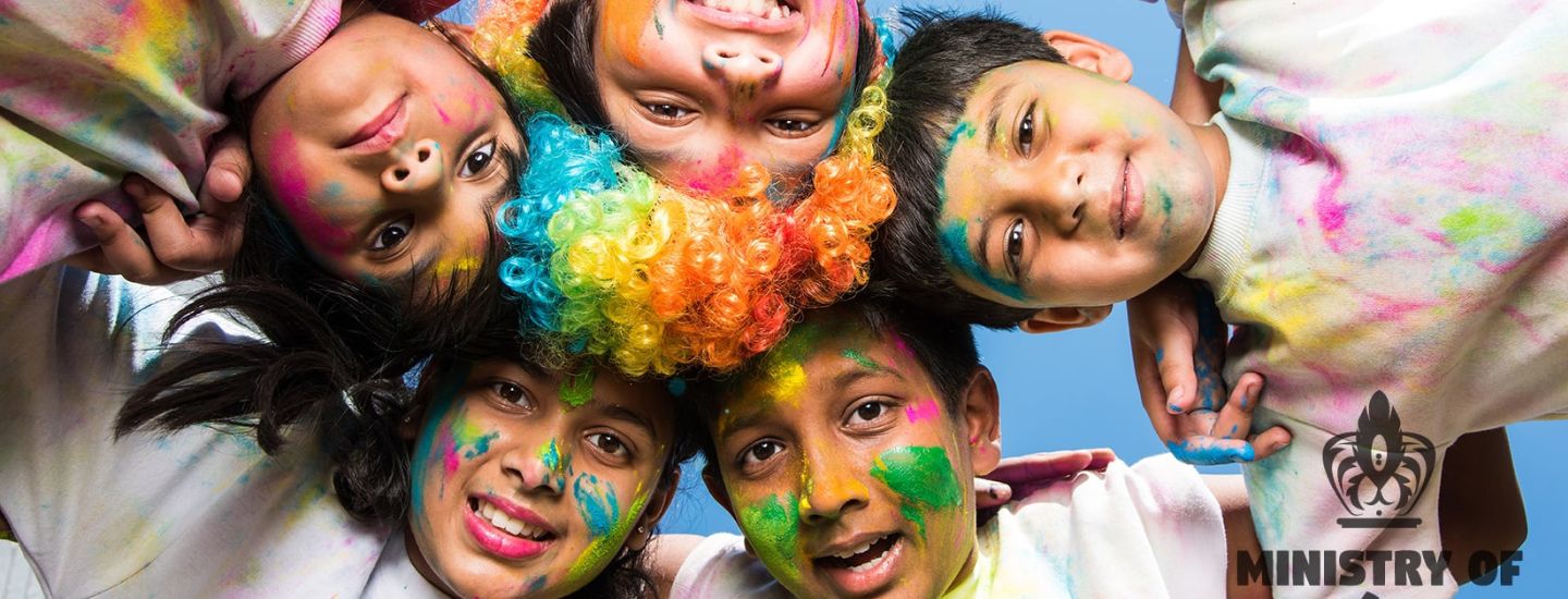 children covered in colour powder in a circle