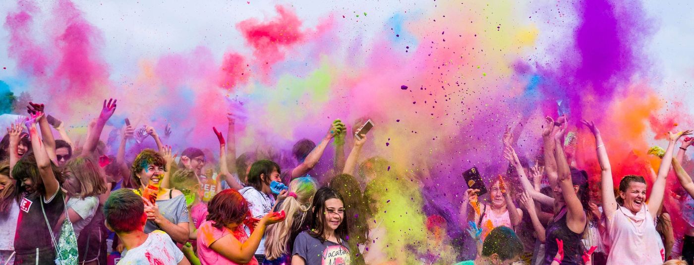Large group of people throwing colour powder