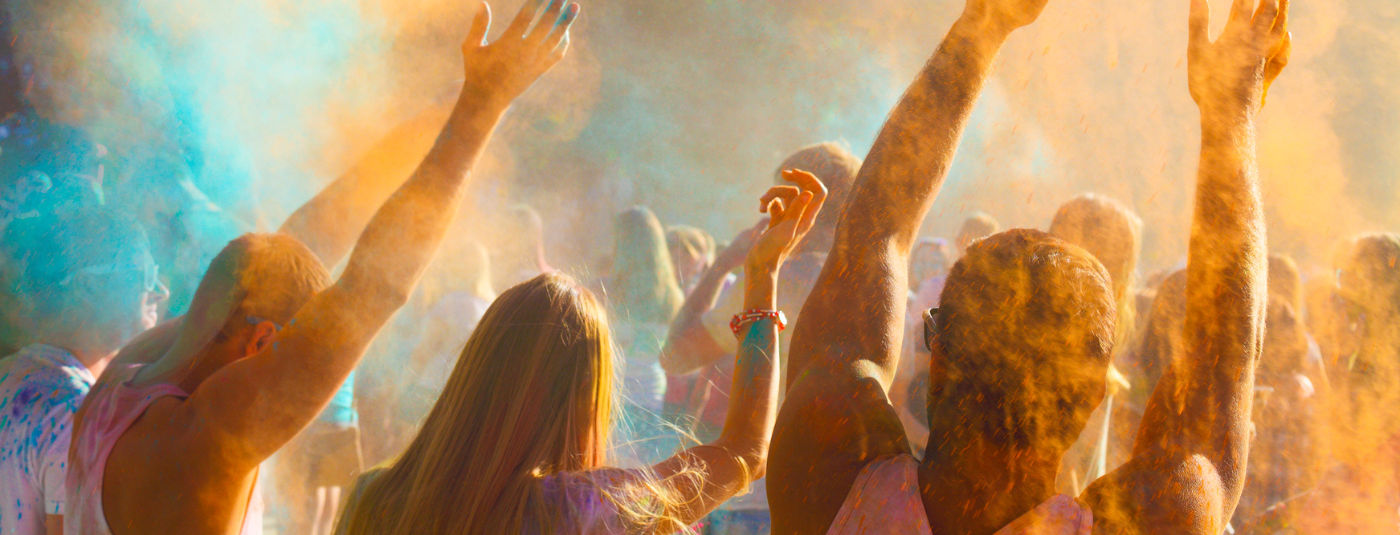 People throwing colour powder at a festival