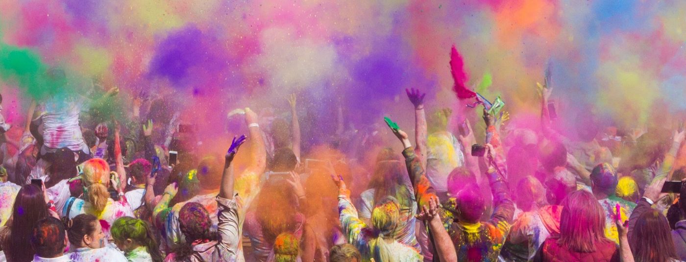 People celebrating Holi with colour powder