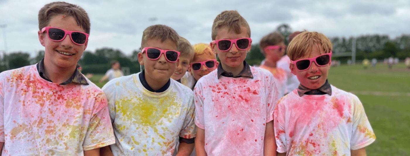 Children covered in colour powder after colour run