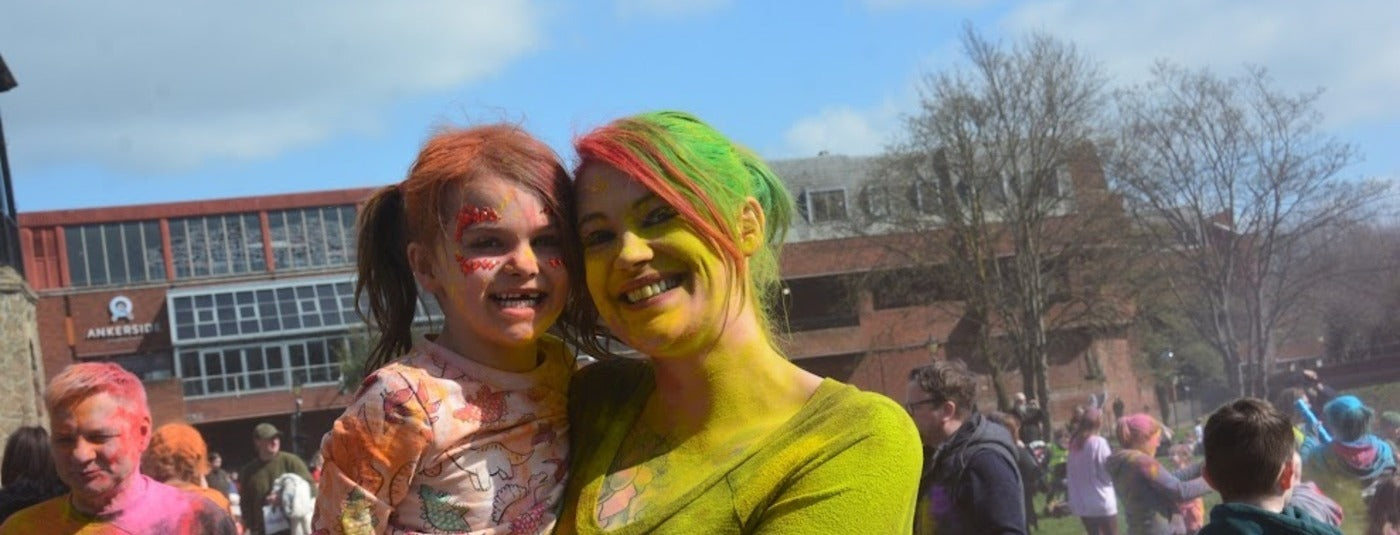 Mother and daughter at colour powder event