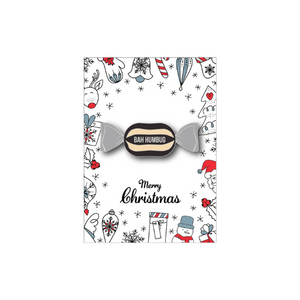 Christmas-themed candy badge with 'Bah Humbug' text on a decorative card with holiday illustrations.