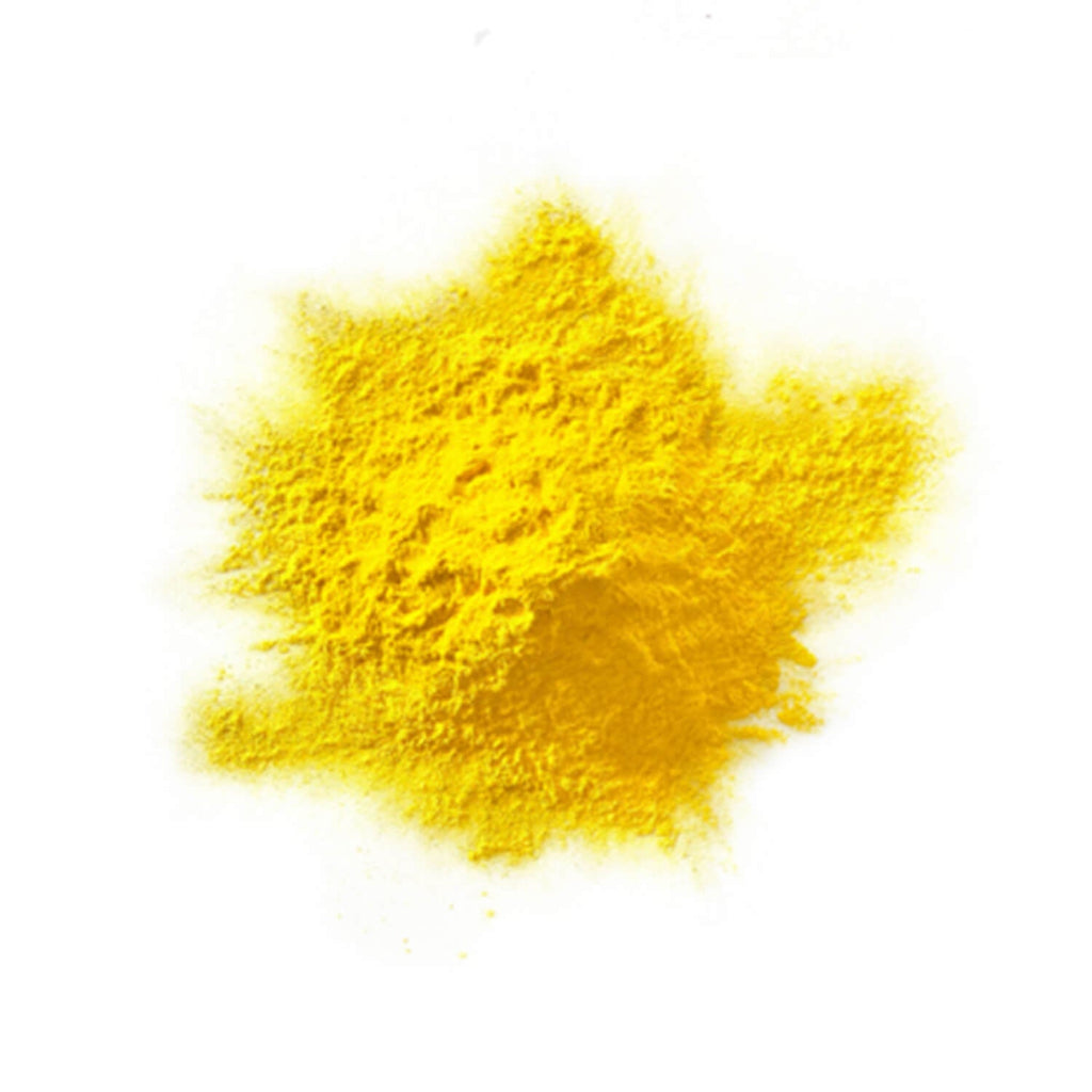 Yellow colour powder in a heap on a white background.