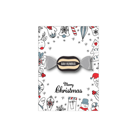 Christmas-themed candy badge with 'Bah Humbug' text on a decorative card with holiday illustrations.