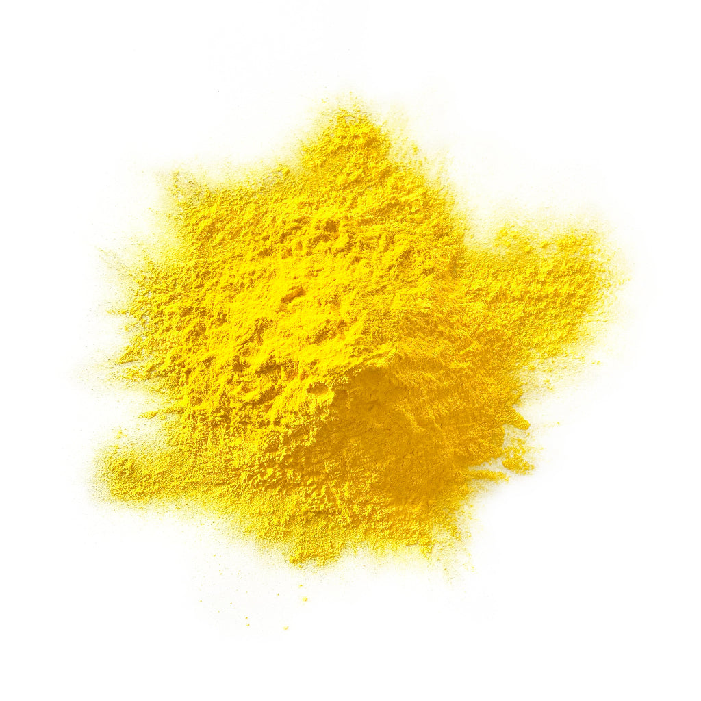 Yellow colour powder in a heap on a white background.