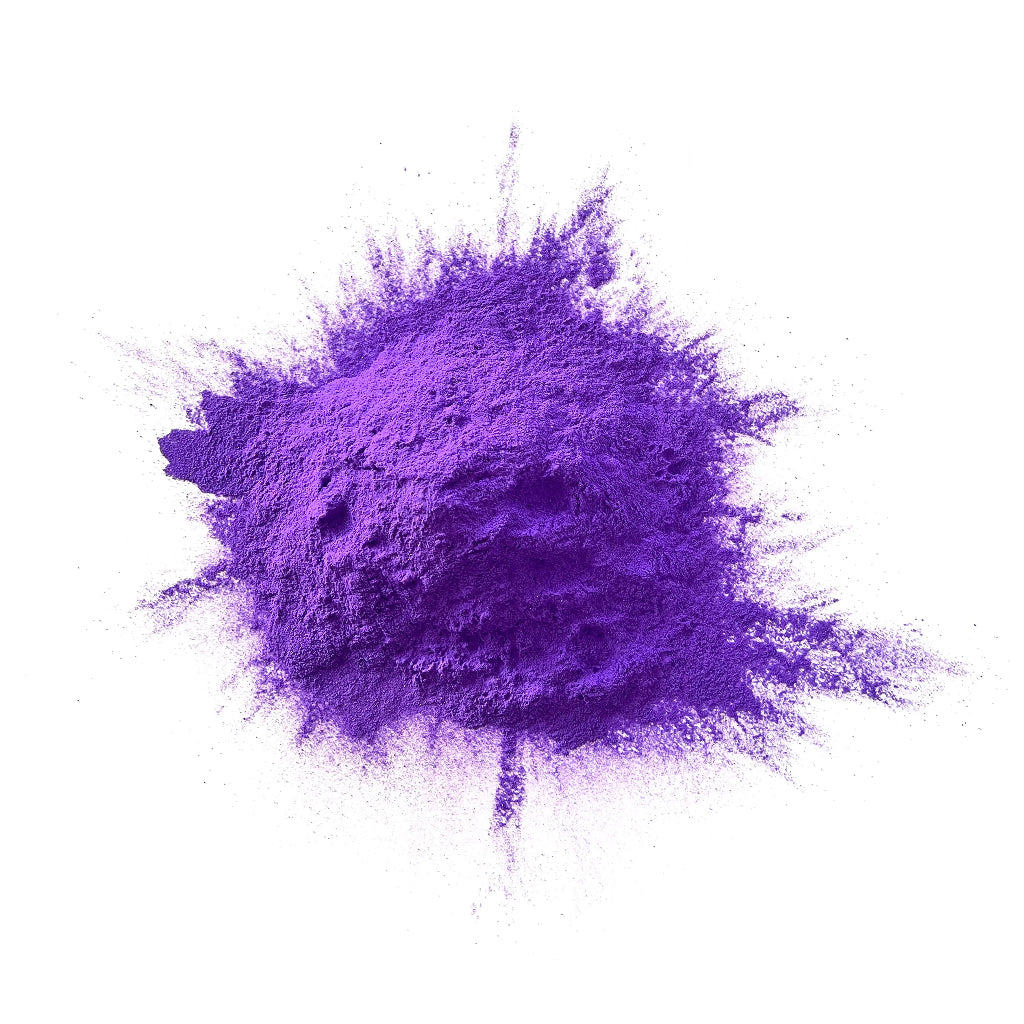 Purple colour powder in a heap on a white background.