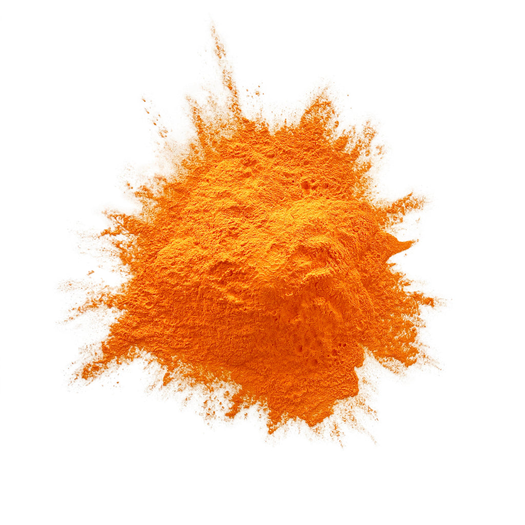 Orange colour powder in a heap on a white background.