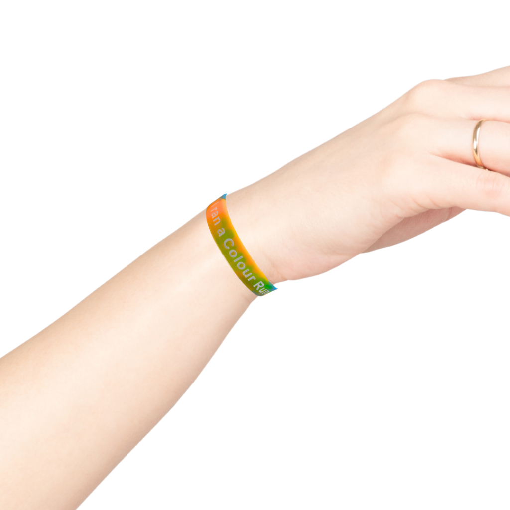 A woman weating a colour run wristband.