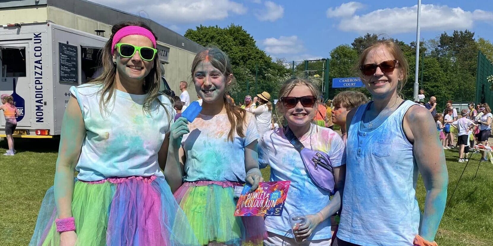 Four women standing together after taking part in a school colour run