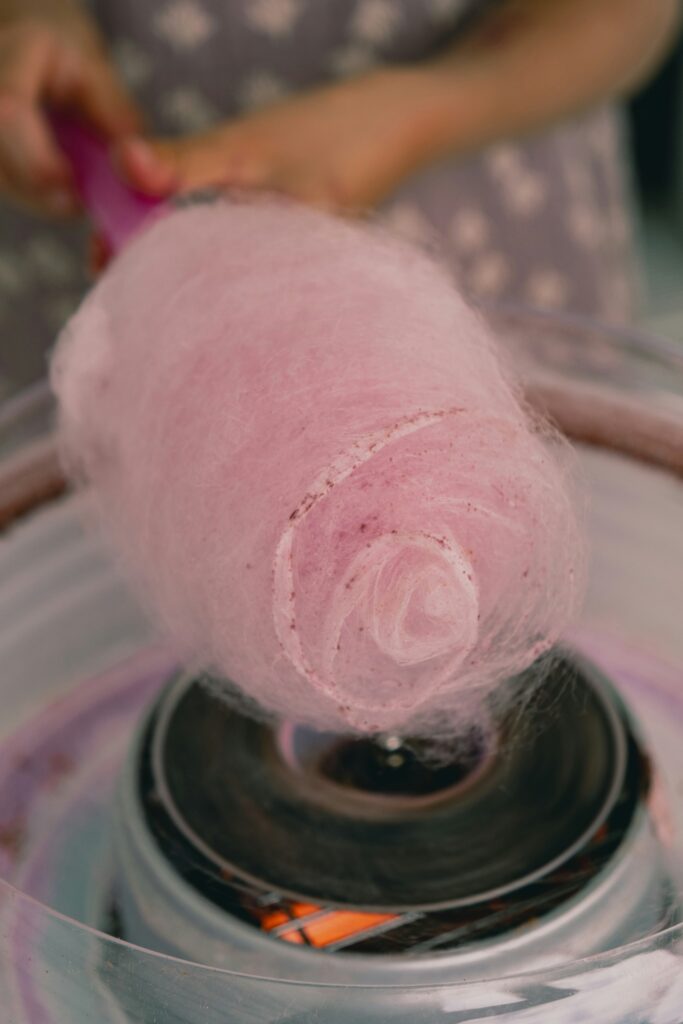 Pink candy floss being made as a refreshment for a school fundraising event